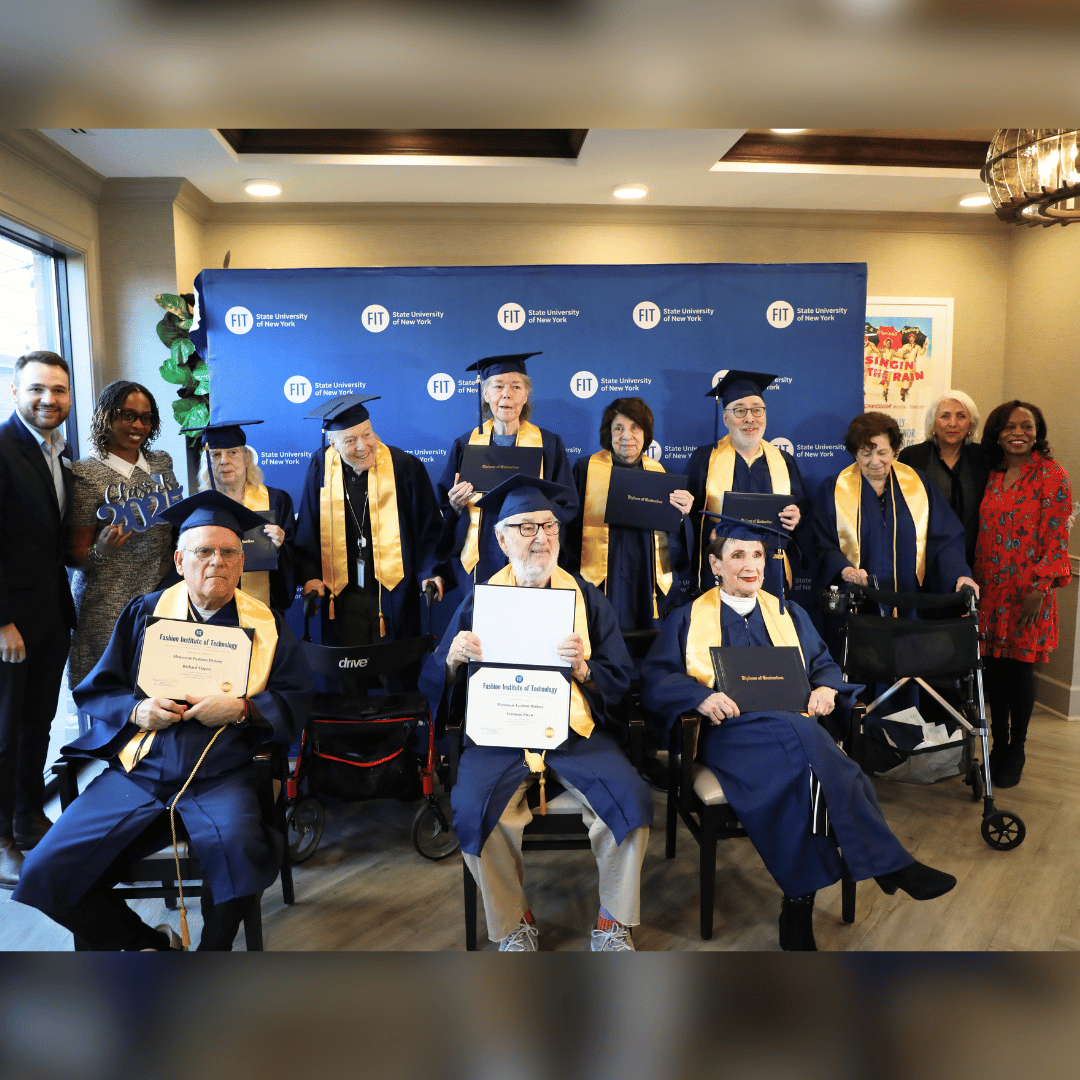 Residents at The Bristal at York Avenue display their certificates while dressed in their caps and gowns.