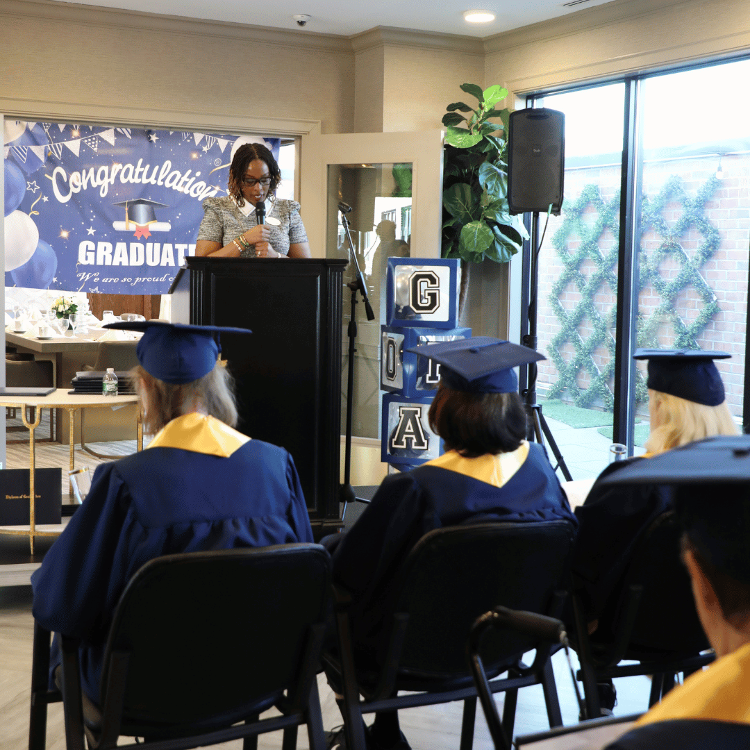 York Avenue team member addresses resident graduates at the ceremony