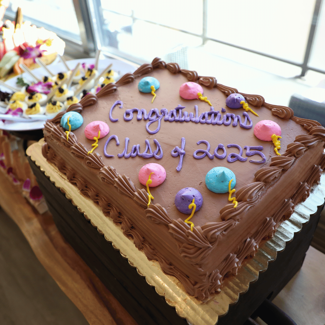 A chocolate cake with the words Congratulations Class of 2025 was presented to the graduates