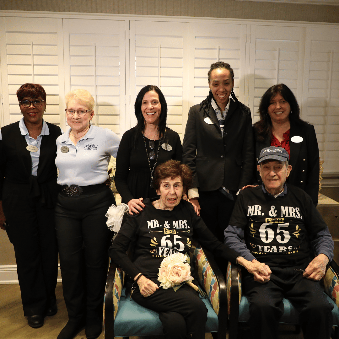 Sidney and Carole Zirlin pose with team members from The Bristal at East Meadow