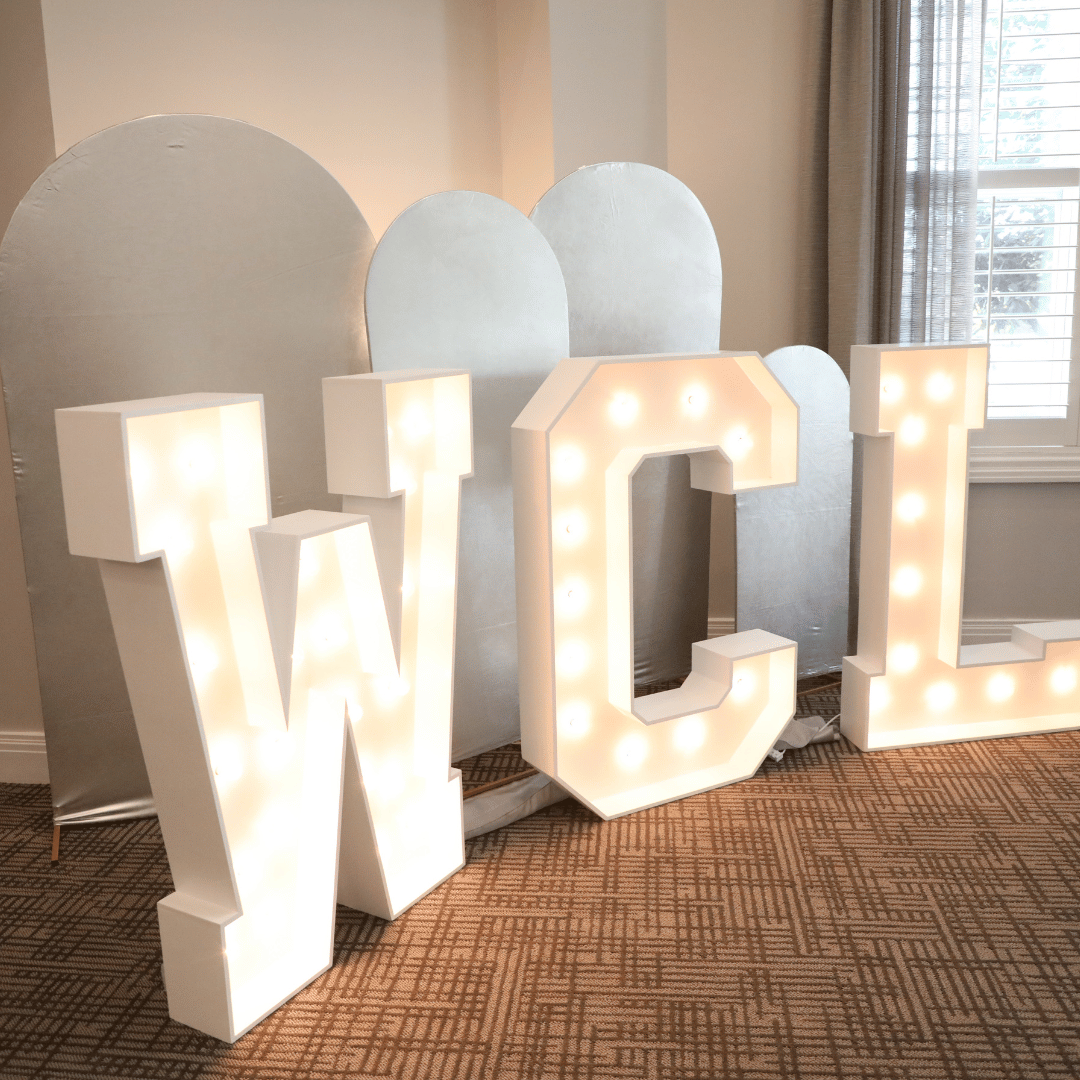 Letters WCL representing Woodcliff Lake lit up prominently at the ribbon cutting event