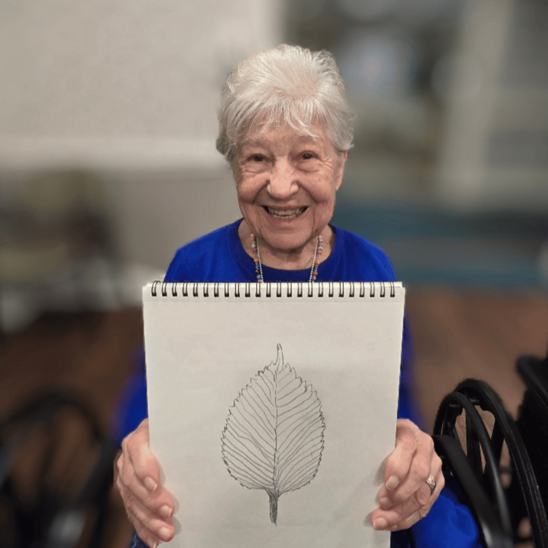 A Massapequa resident shows off creative art work during immersive meditation day at The Bristal
