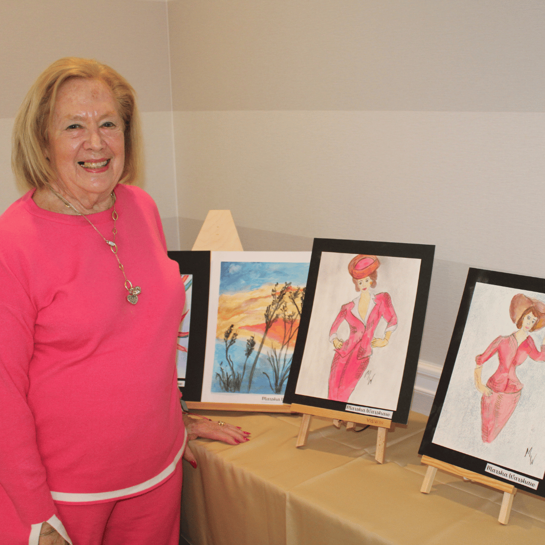 Resident at The Bristal at Jericho poses with her art work