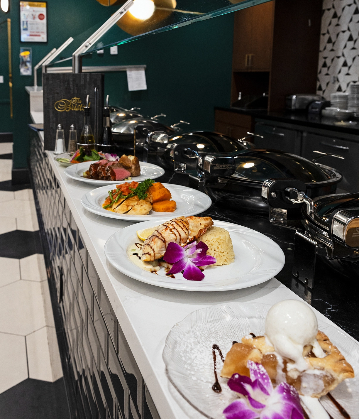 The Bristal Dining - professionally presented plates lined up to be served in The Bristal kitchen