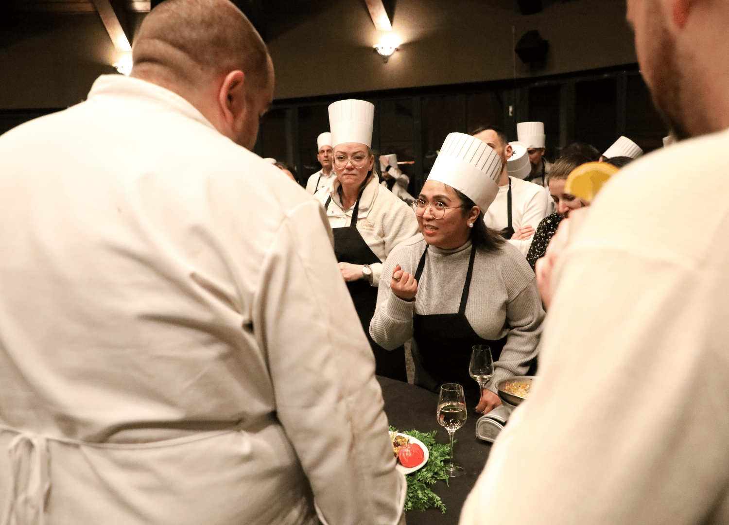 a tean explains their use of ingredients for the Iron Chef competition at The 2026 Leadership Summit for The Bristal Assisted Living